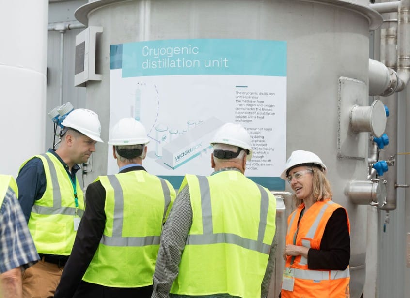 people standing in front of cryogenic unit